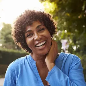 Black woman smiling after receiving Neurofeedback training.